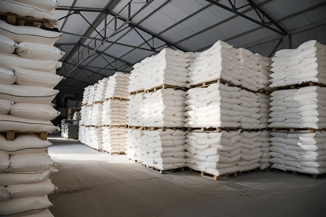 Large warehouse with stacks of white bags on pallets